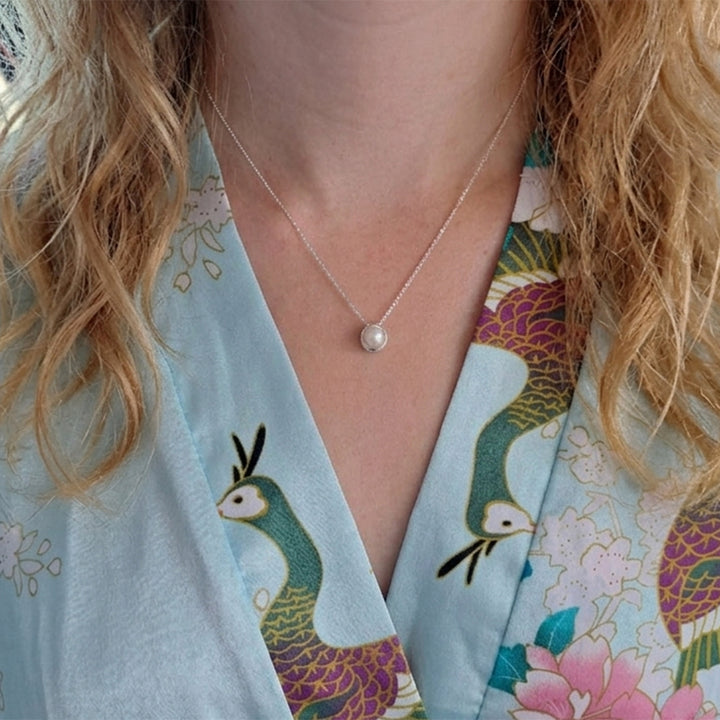 Model wearing a sterling silver pearl pendant necklace