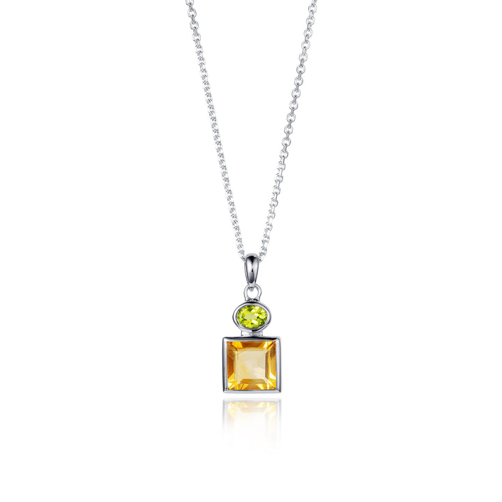 Closeup of a silver pendant and chain with two gemstones