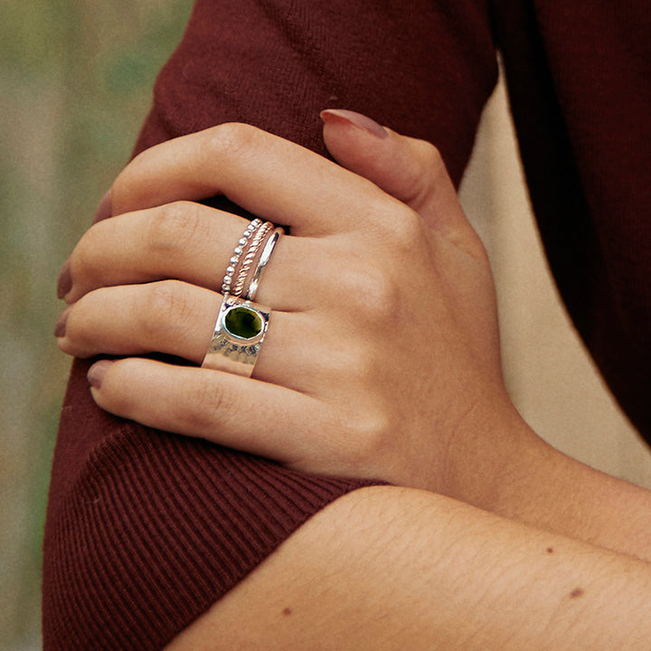 Close-up of woman wearing a sterling silver wide band ring with natural smoky quartz gemstone