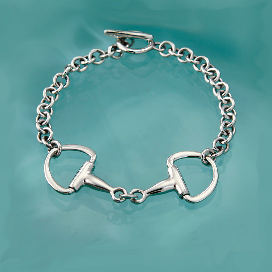 Sterling silver snaffle bit chain bracelet on an aqua background