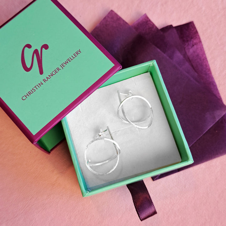 Sterling silver spiral stud earrings in Christin Ranger Jewellery gift packaging
