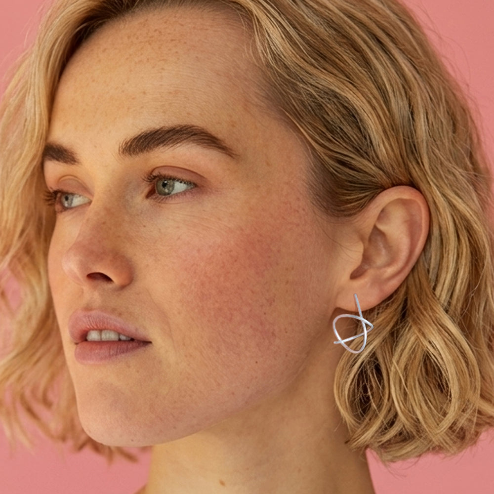 Woman wearing Sterling silver spiral stud earrings