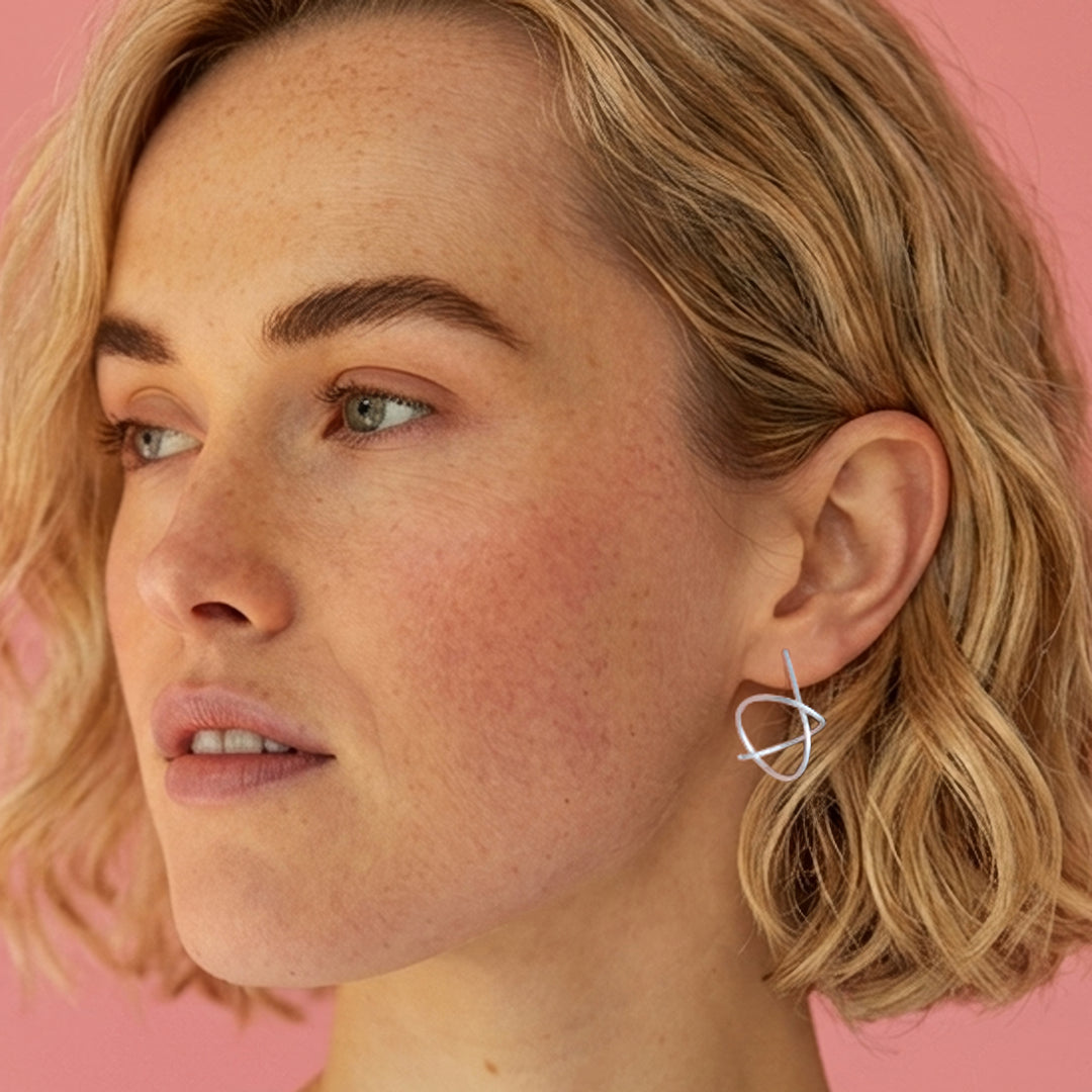 Woman wearing Sterling silver spiral stud earrings