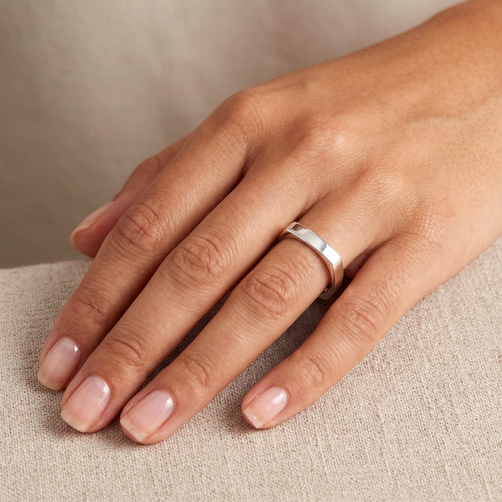 Sterling silver square band ring on a hand