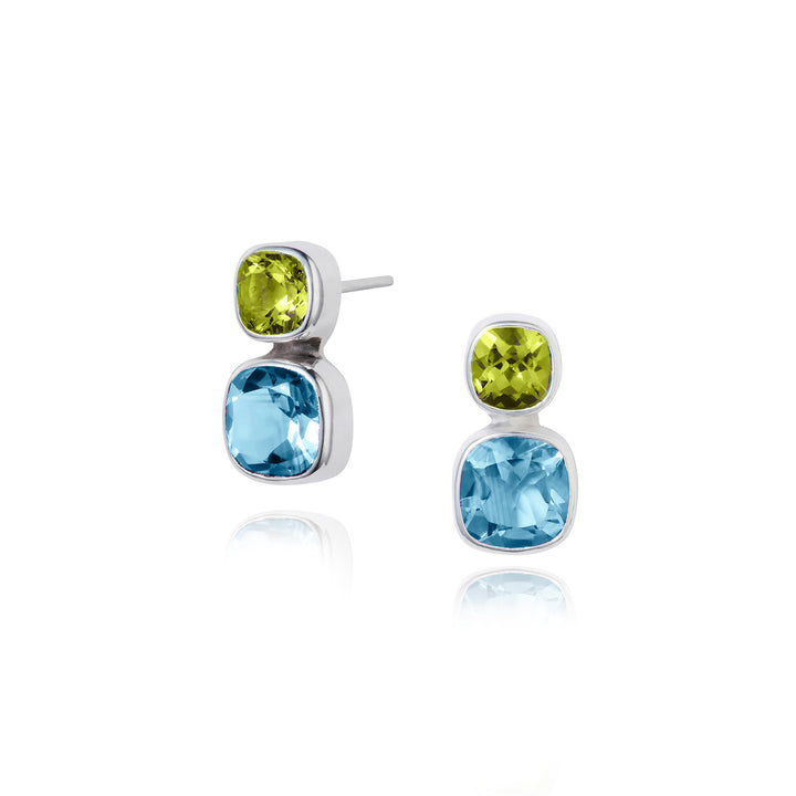 Pair of earrings with green and blue gemstones on a white background