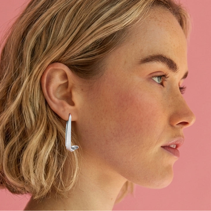 Model wearing sterling silver swirl threader hoop earrings