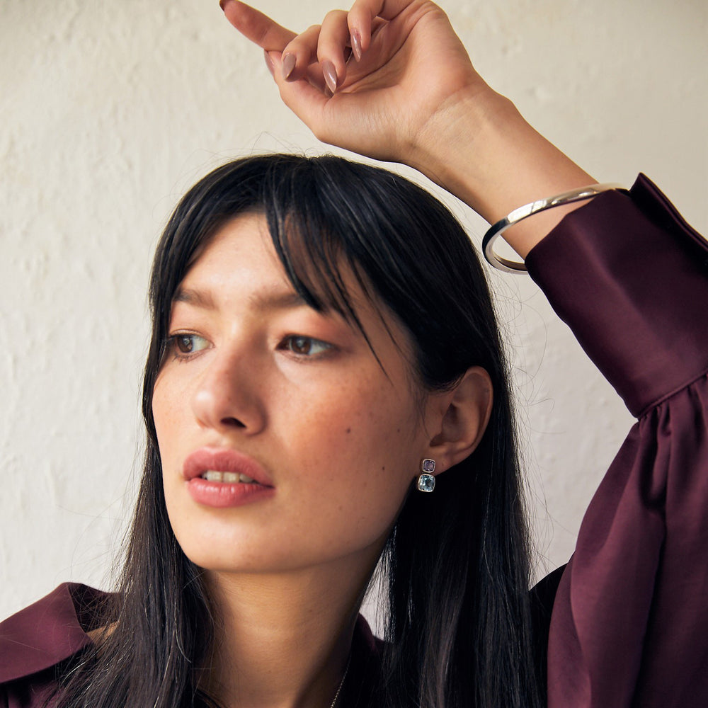 woman wearing a sterling silver wave bangle made of square tubing