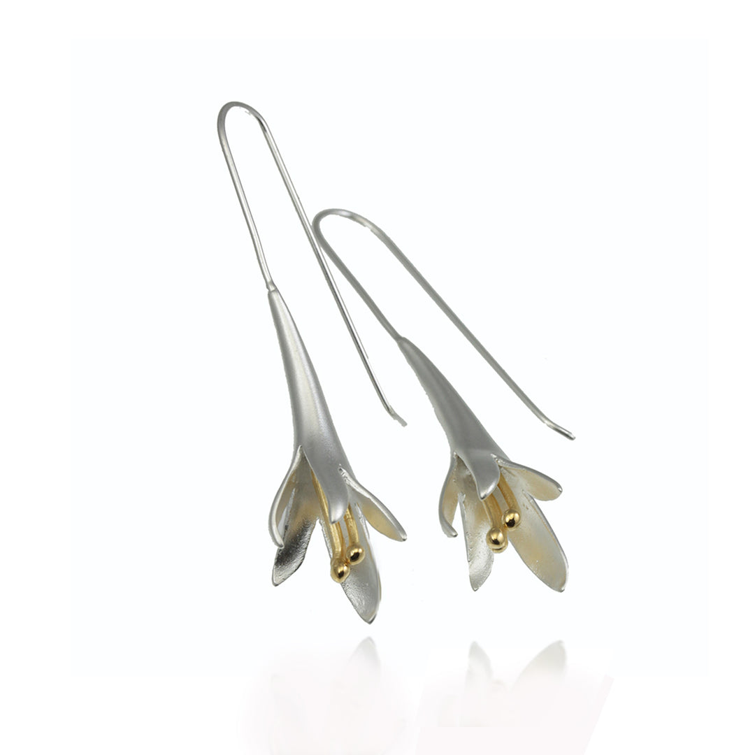 Silver floral earrings with gold accents on a white background 