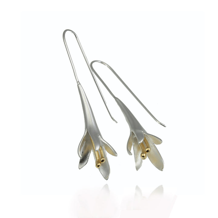 Silver floral earrings with gold accents on a white background 