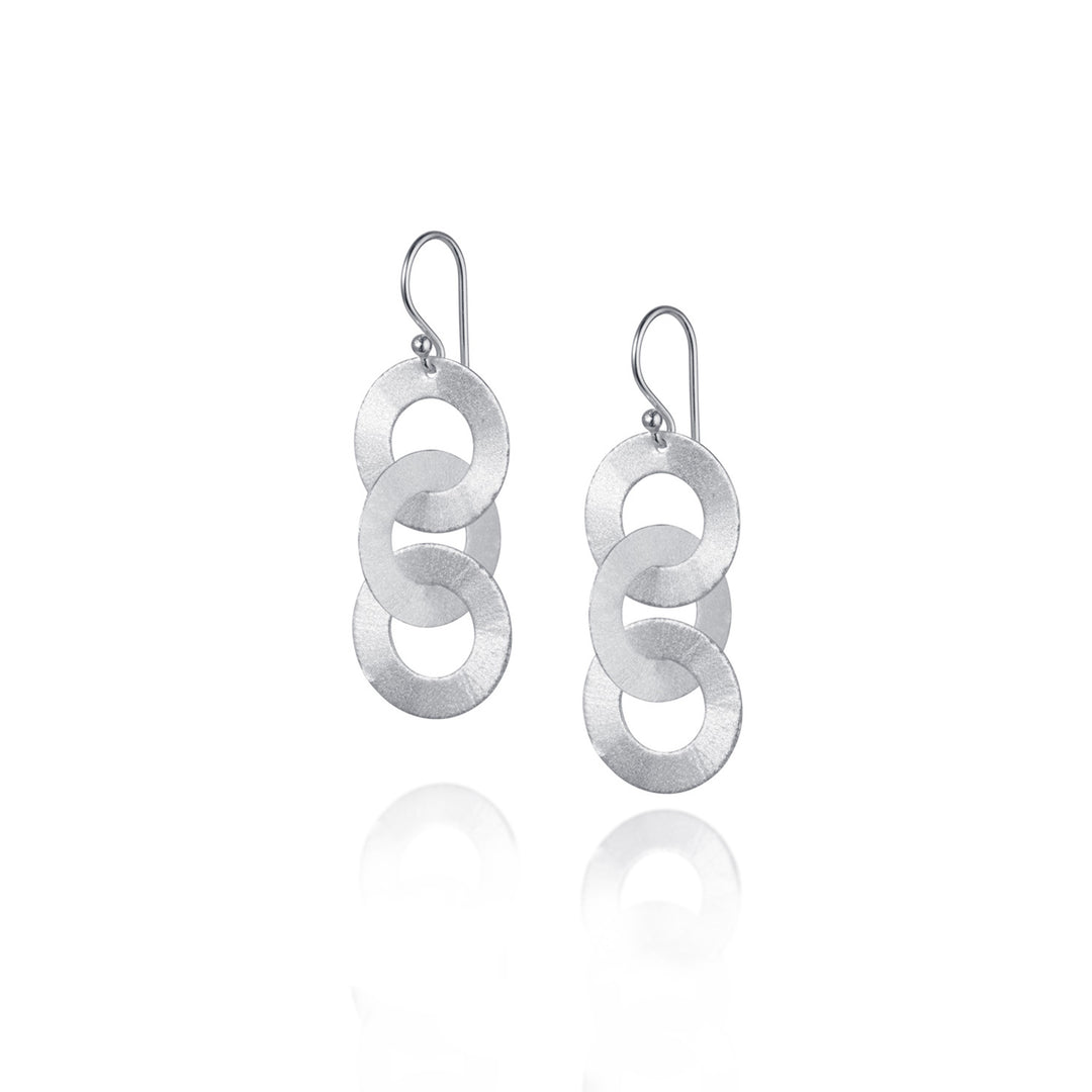 Silver three hoop drop earrings on a white background