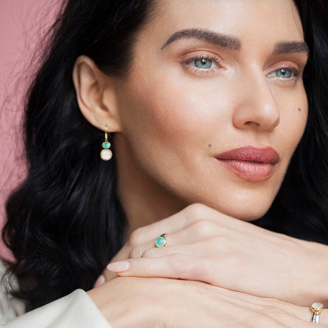 Woman wearing a natural amazonite ring in sterling silver with 18ct gold vermeil setting and matching necklace