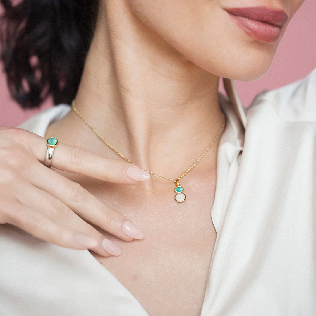 Model wearing a amazonite and moonstone necklace with a matching silver ring