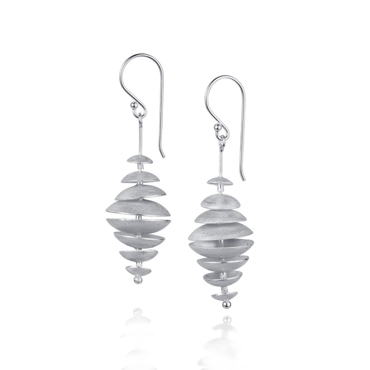 Silver multi-disk dangle earrings on a white background