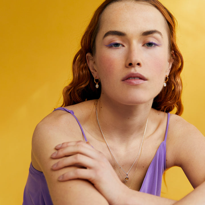 Model Shot of Gold and Moonstone Huggie Hoop Earrings