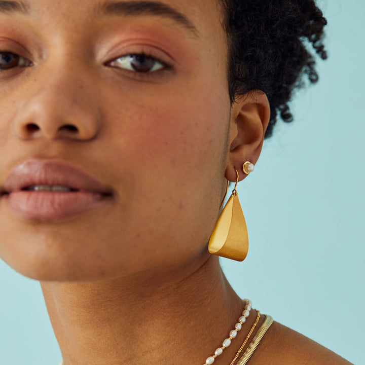 Model Wearing Large Pear Drop Golden Hoop Earrings