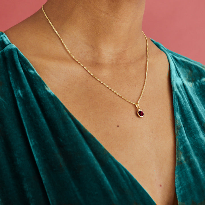 Model Wearing Gold and Garnet Maya Pendant