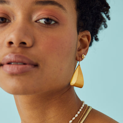 Model Wearing Gold and Pearl Stud Earrings
