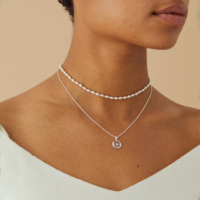 Model Wearing Silver Compass Necklace with July Birthstone Ruby