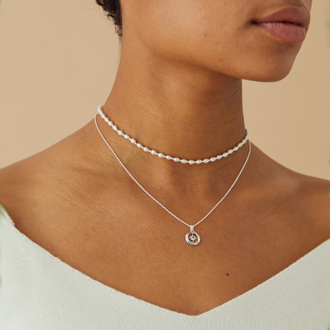 Model Wearing Silver Compass Necklace with August Birthstone Peridot