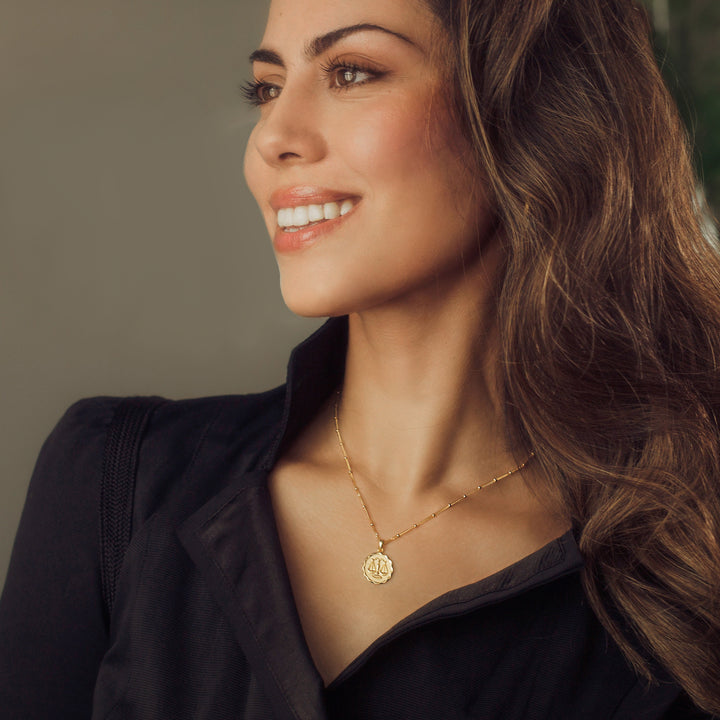 Model Wearing Gold Zodiac Pendant Necklace