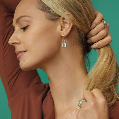 Model Wearing Silver Earrings with Blue Topaz and Peridot