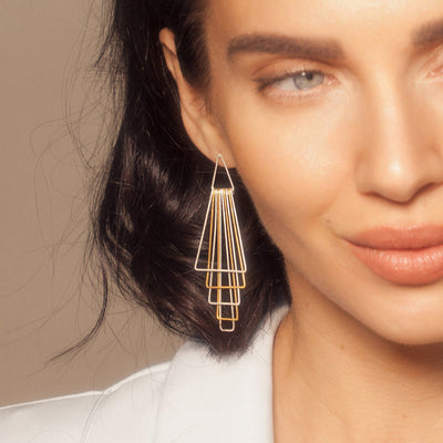 Model Wearing Silver and Gold Pyramid Earrings