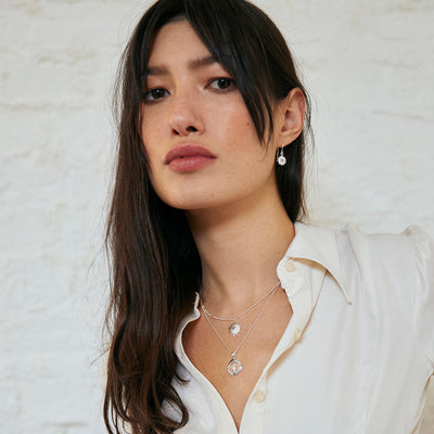 Model Wearing Silver and White Topaz Sun Necklace
