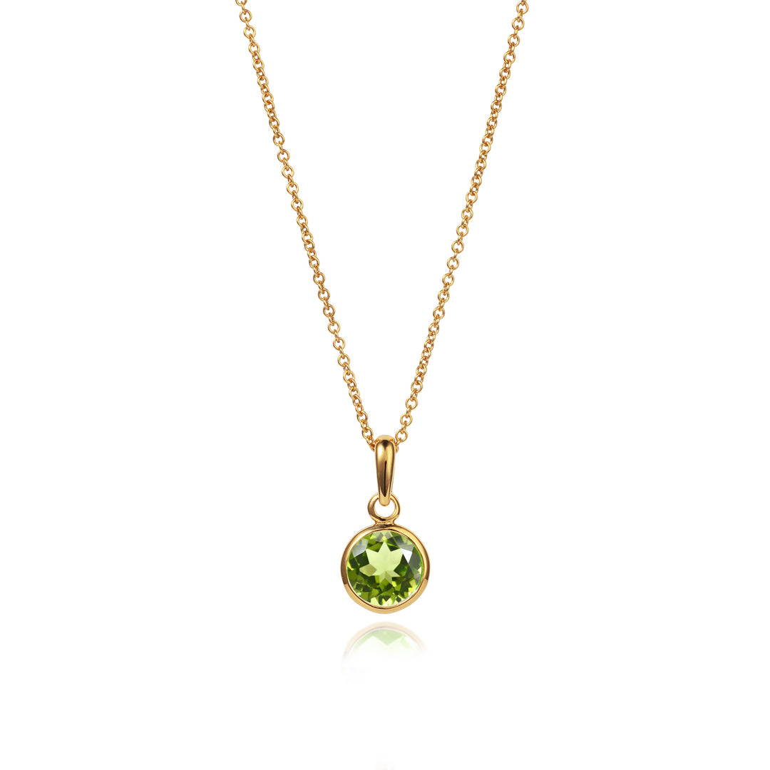 A gold vermeil pendant necklace featuring a round peridot gemstone pendant attached to a gold chain.