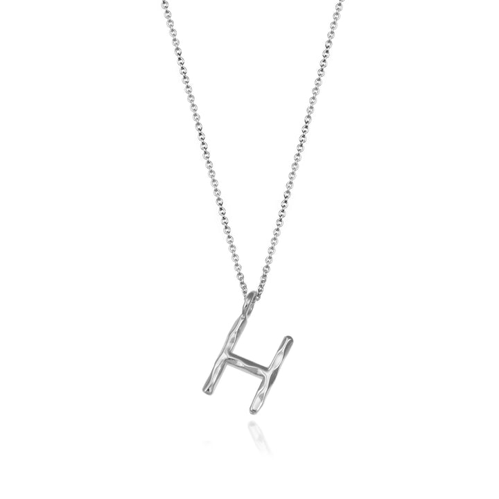 Sterling silver letter H initial necklace pendant with chain on a white background.