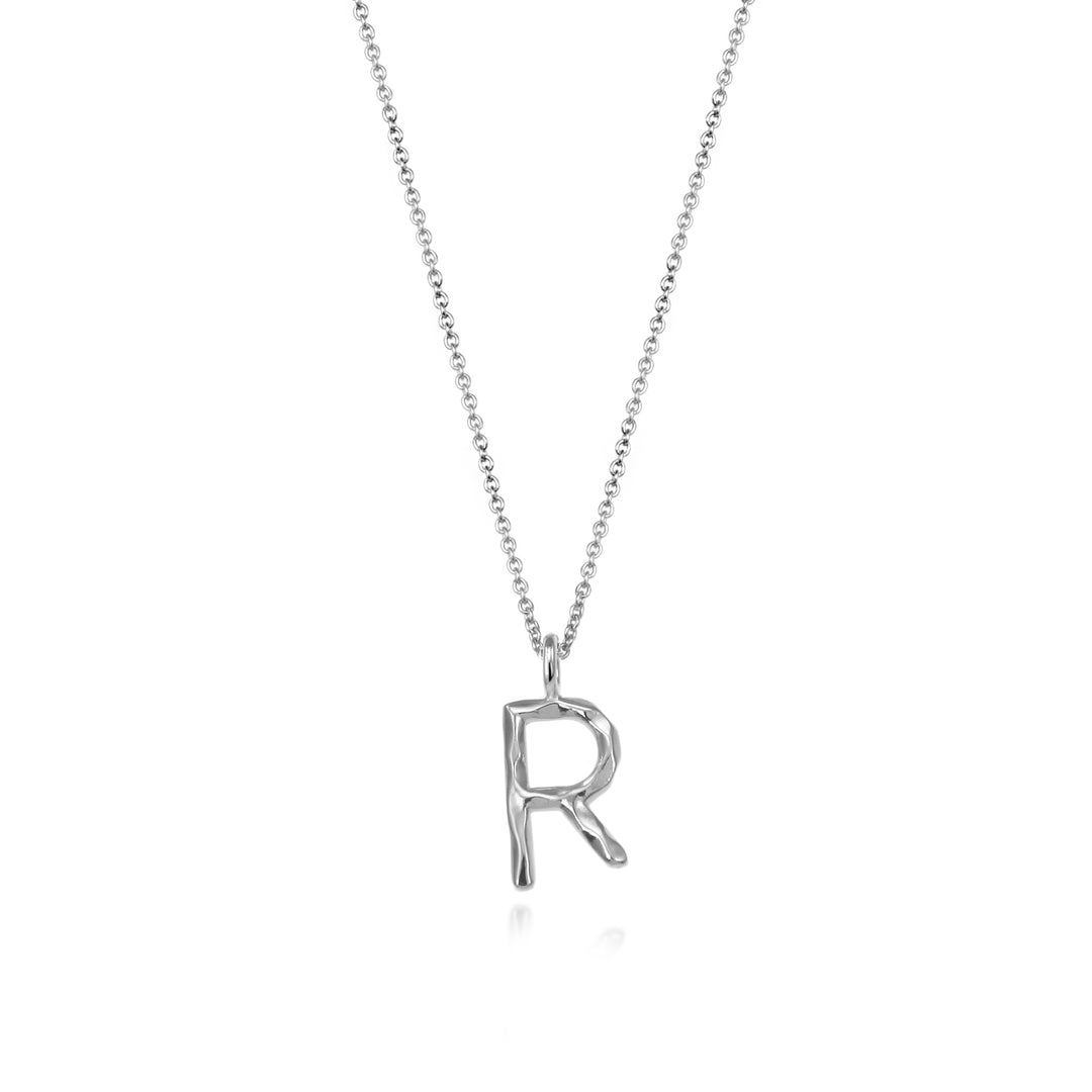 Sterling silver letter R initial necklace pendant with chain on a white background.