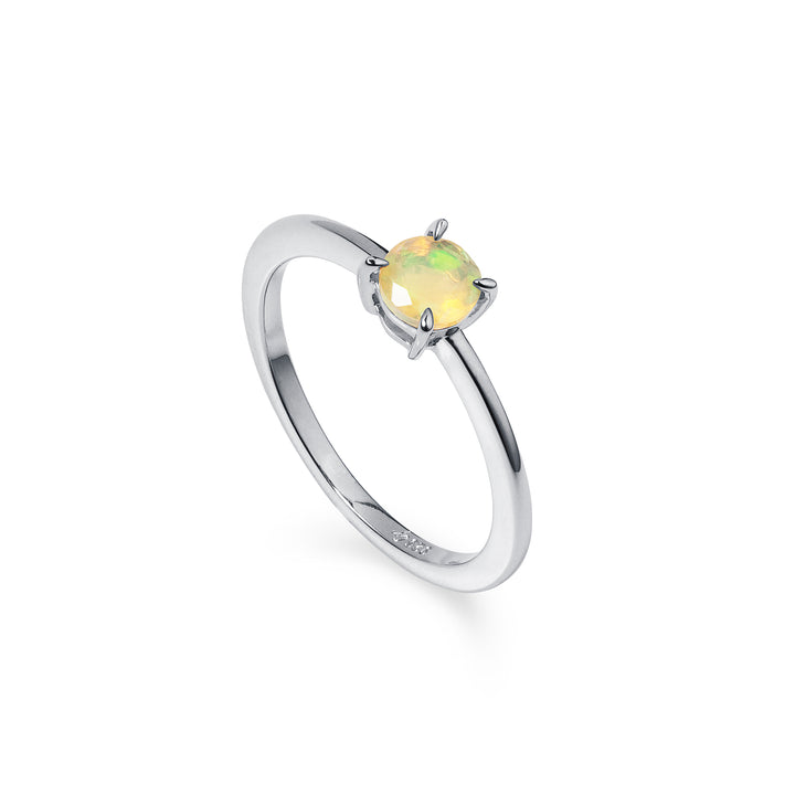 A silver ring with a single opal gemstone on a white background